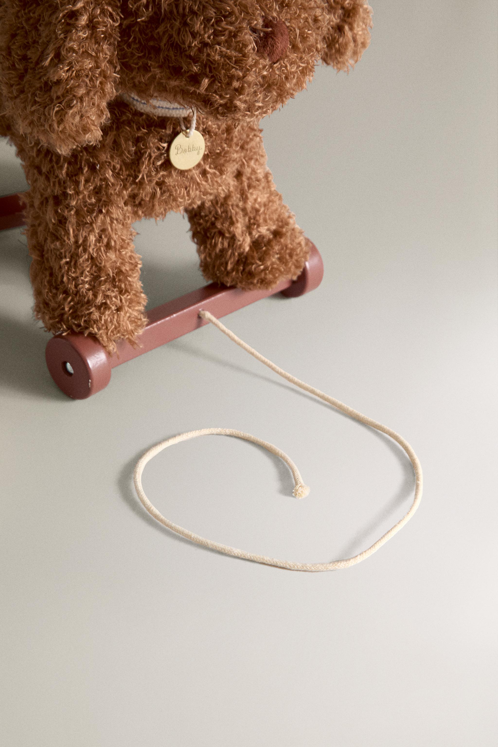 PELUCHE ENFANT CHIEN À ROUES